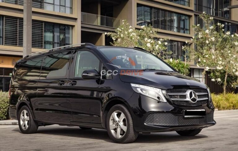 A sleek black luxury sedan parked in front of a modern building, showcasing GCC Drive's premium chauffeur services in Dubai.