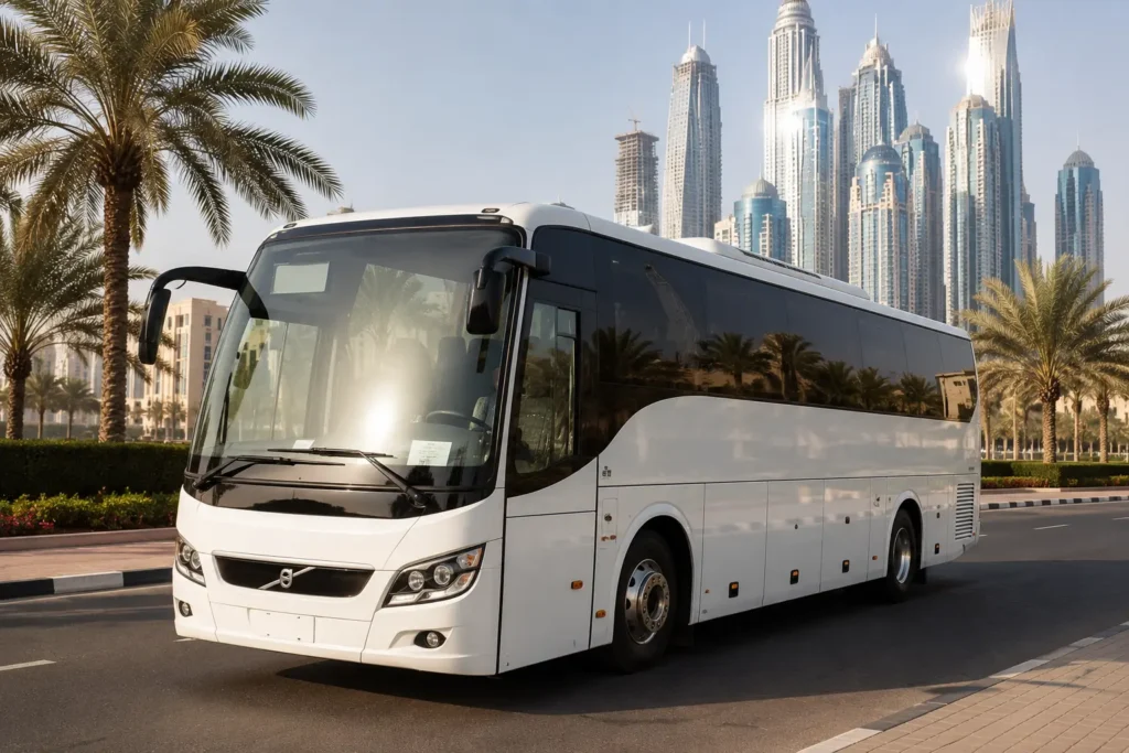 Modern 30 Seater Luxury Bus in Dubai parked beside a palm-lined boulevard with Dubai's skyline, offering comfortable transportation for corporate events, family trips, and sightseeing groups.