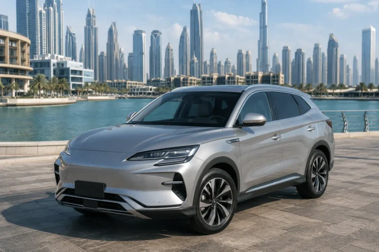 Silver BYD Song PLUS EV 2025 parked on a Dubai waterfront promenade with the modern skyline in the background.