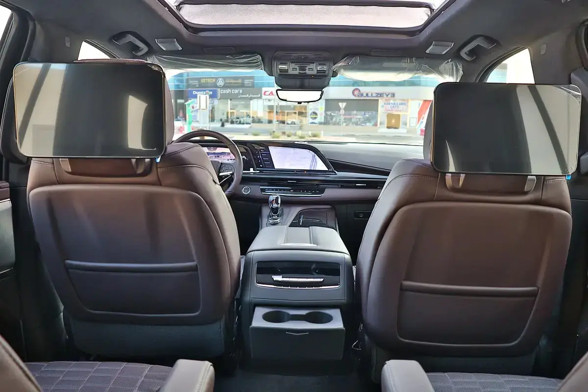 The image shows the rear passenger cabin of a luxury full-size SUV, specifically appearing to be a Cadillac Escalade.